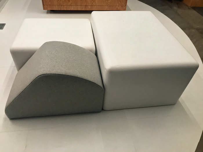 In the center of the store are geometric chair cushions for shoppers, which can be easily moved to provide space for community events and physical activities.