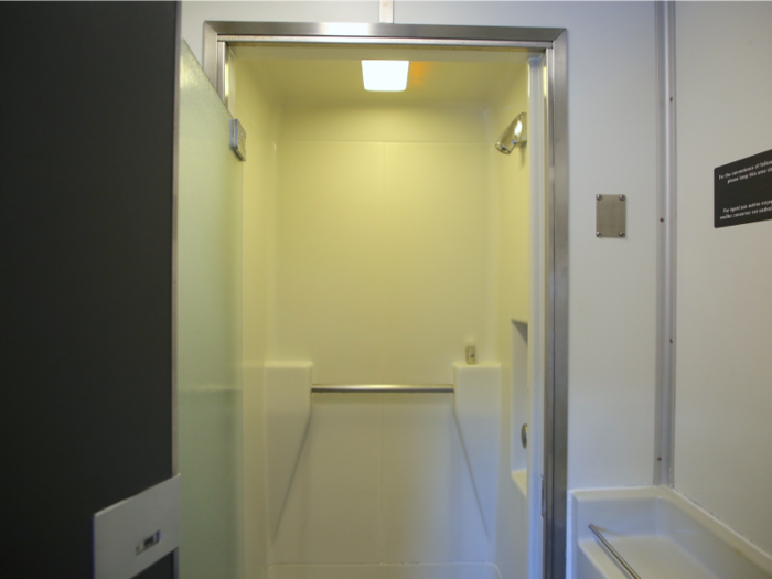 The actual shower area was surprisingly spacious. The room had a single shower, a ledge for clothing and a bag ...