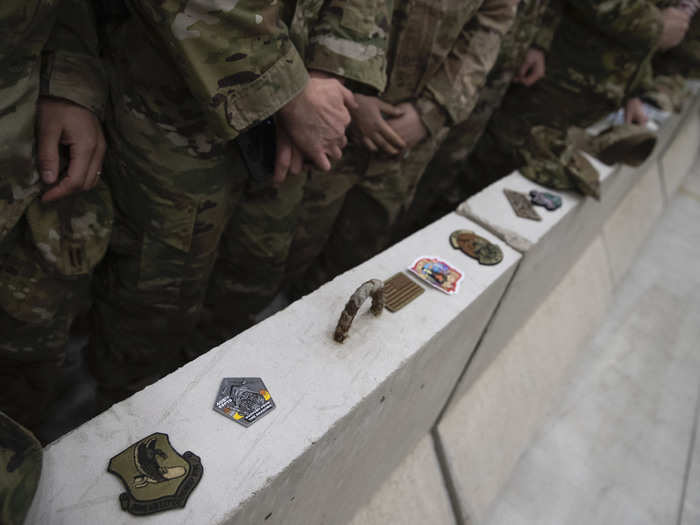 They lined up their patches and coins for Trump to inspect.