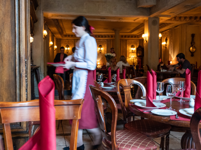 The women wore long red skirts, white shirts and aprons, and red ribbons tying their hair back.