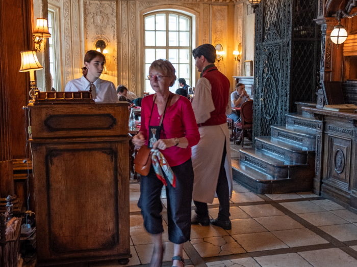 The hostess stood at a wooden podium by the door.