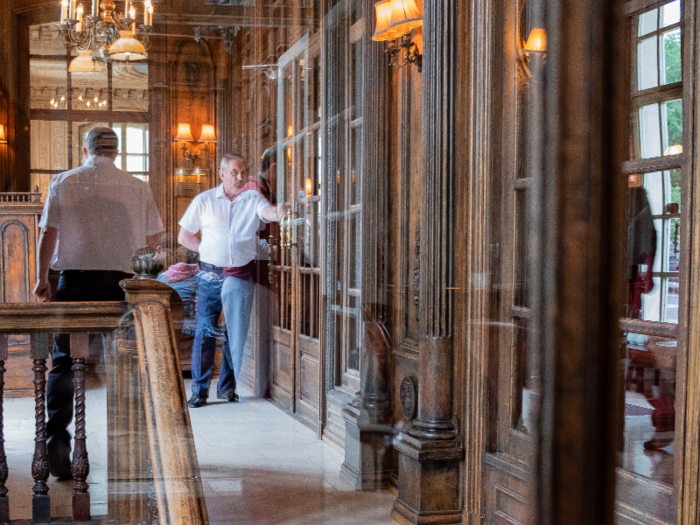 A man in a white polo shirt and jeans opened the heavy wooden doors for me as I walked into the restaurant.