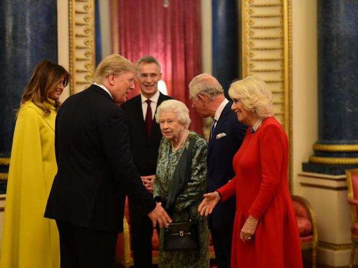 Trump greets Camilla, Duchess of Cornwall, alongside Prince Charles, who is next in line for the throne.