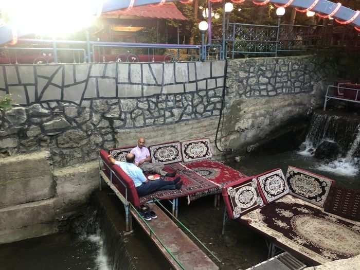 Along the way are many restaurants and cafes built into the mountain. These seats are on top of a running river, and people use them to sit on while drinking tea and smoking hookah.