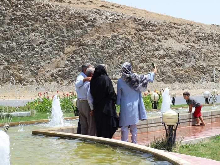 People liked the fountain and were taking selfies in front of it.