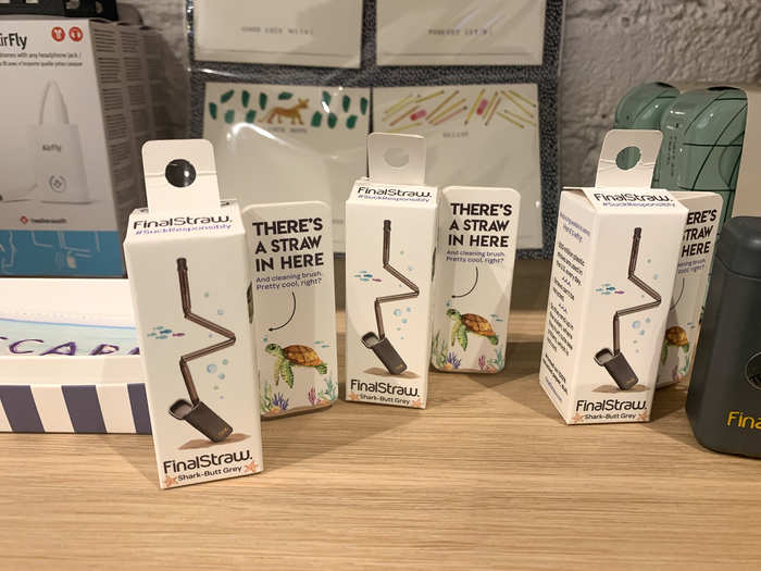 On the shelves above were some practical goods, like collapsible and reusable steel straws and an AirPods adapter for when you need to hook up to a plane