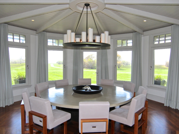 ... and a circular formal dining room with a wall of windows overlooking the grounds.