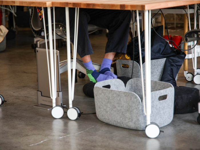 ... and foot cushions are placed beneath their desks.