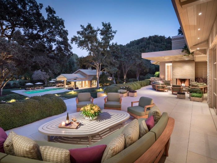 The sprawling outdoor area includes a terrace with a pergola, a pool deck, a tennis court, a bocce ball court, and a labyrinth.