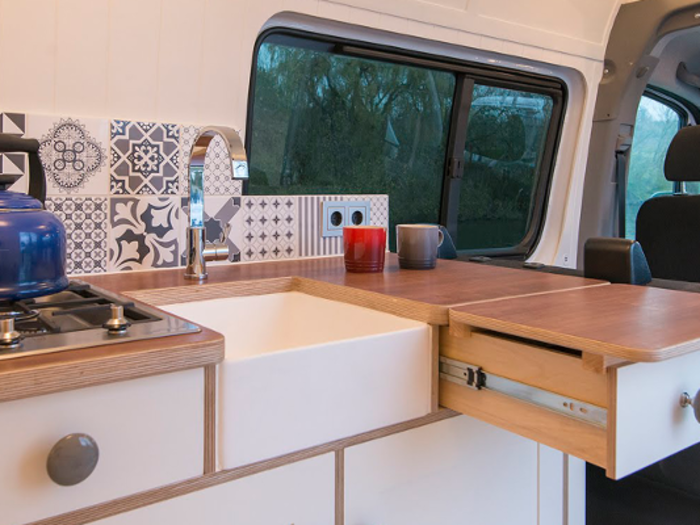 The kitchen was designed around the custom sink, according to This Moving House.