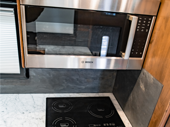 The kitchen has a Bosch microwave, sink, and electric stovetop.