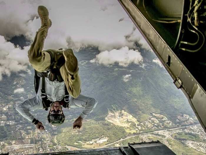 A service member jumps out of a Marine Corps MV-22B Osprey during parachute training at Marine Corps Training Area Bellows, Hawaii, Aug. 13, 2019.