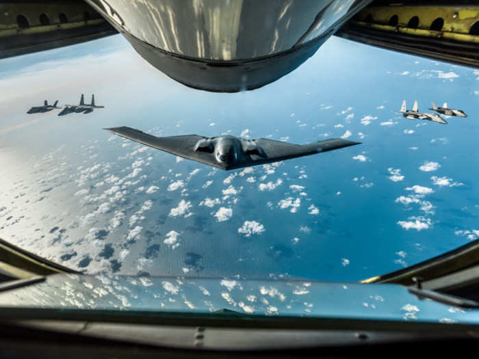 An Air Force B-2 Spirit bomber, two Royal Air Force F-35 Lightning IIs and two F-15 Eagles fly in formation behind a KC-135 Stratotanker during a training mission over England, Sept. 16, 2019.