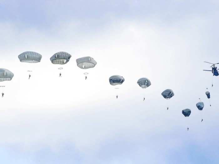 Army paratroopers jump from a CH-47 Chinook helicopter over the Bunker drop zone at Grafenwoehr Training Area, Germany, Aug. 14, 2019.