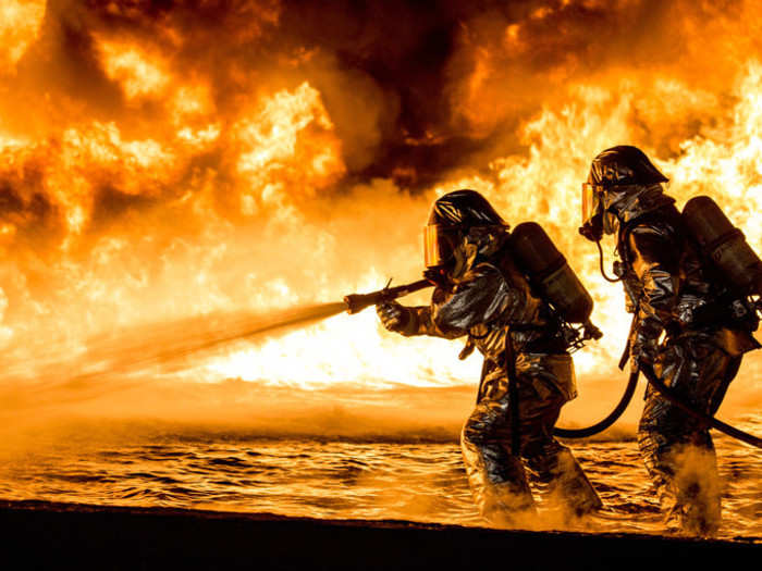 Marines use a fire hose to extinguish a fuel fire during live-burn training at Marine Corps Air Station Futenma in Okinawa, Japan, Jan. 25, 2019.