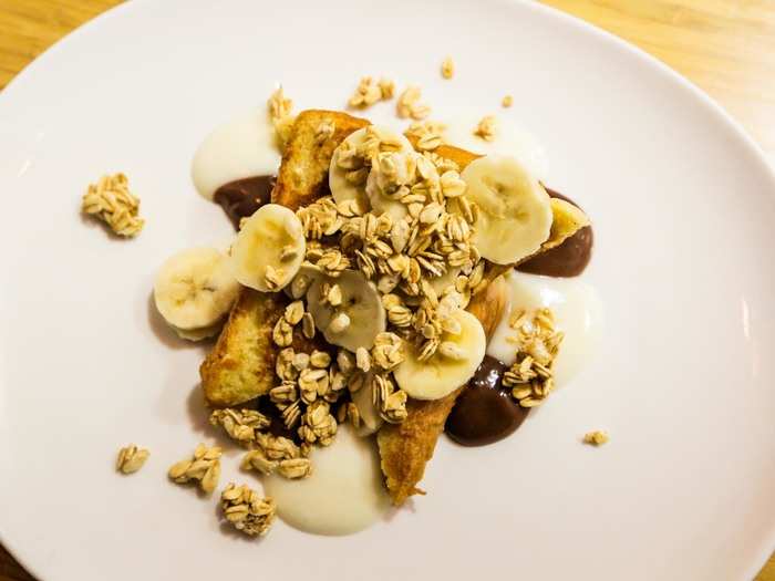 This dish was topped with sliced bananas, granola, amaretto sauce, and chocolate ginger sauce.