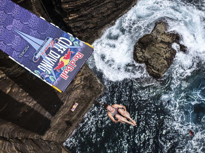 Jessica Macaulay of the UK dives from the 21-meter platform at Islet Vila Franca do Campo during the Red Bull Cliff Diving World Series at Sao Miguel, Azores, Portugal.