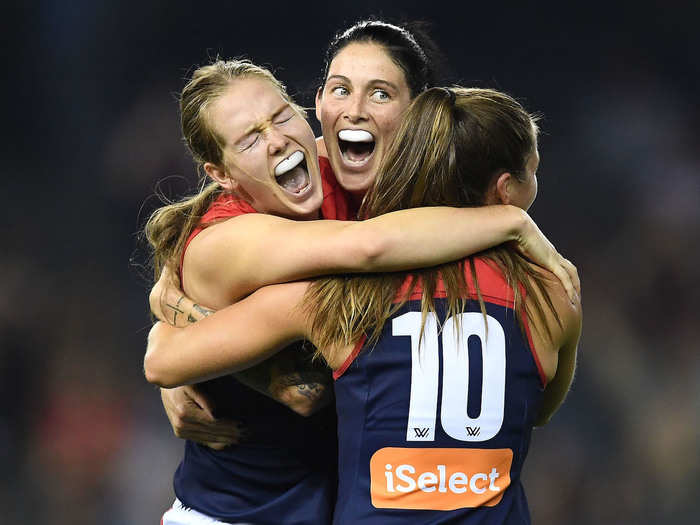 The Melbourne Demons celebrate winning an Australian Football League Women