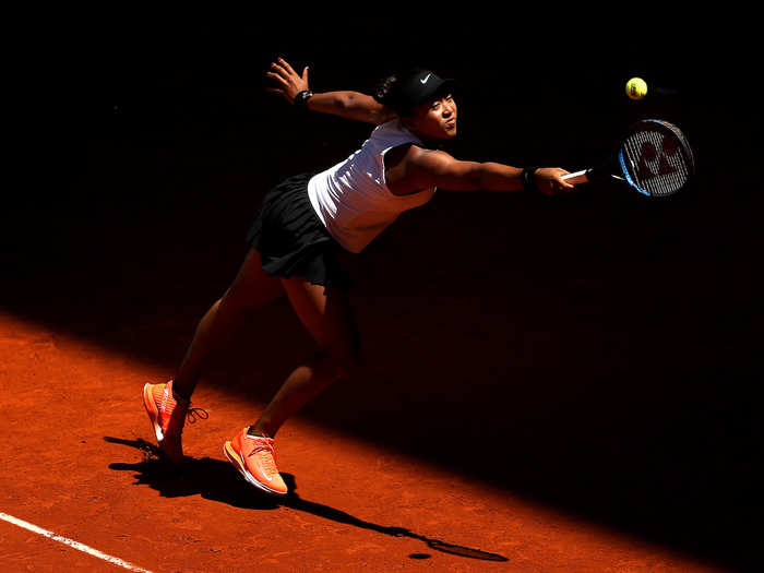 Naomi Osaka returns the ball in her match against Belinda Bencic at the Mutua Madrid Open.