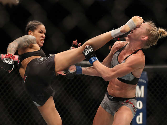 Amanda Nunes of Brazil kicks Holly Holm in their UFC bantamweight championship fight during UFC 239 in Las Vegas, Nevada.