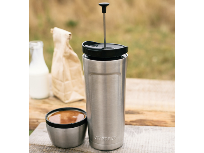 A stainless steel tumbler with a French press