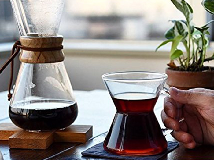 A sleek, glass, pour-over coffee pot