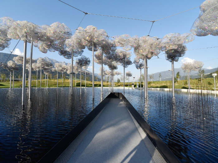 The Crystal Cloud is located over the black Mirror Pool and changes color depending on the weather. Created by Andy Cao and Xavier Perrot, The Crystal Cloud installation consists of nearly 800,000 hand-mounted Swarovski crystals and 2,000 crystal fireflies.