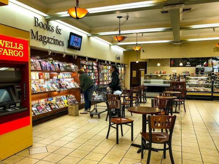 Near the entrance, there was a small cafe area with books, magazines, and a bakery.