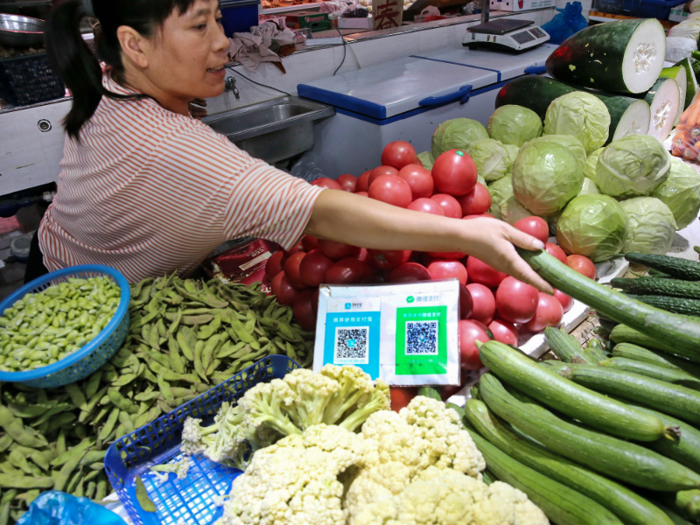 WeChat QR codes are pushing China into becoming a cashless society. Even its street vendors use WeChat Pay to sell vegetables.