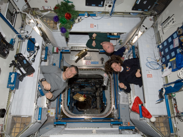 On Christmas morning astronauts emerge from their sleeping quarters to find their stockings and presents just like on Earth.