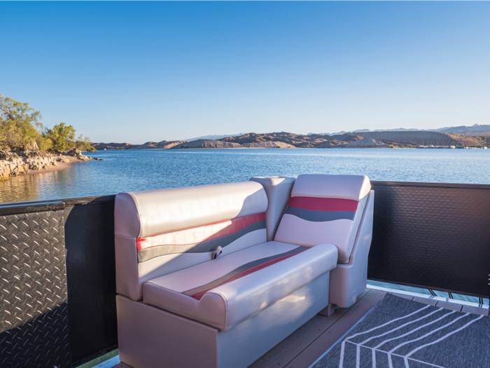 The houseboat also comes with lounge chairs for relaxing outside.