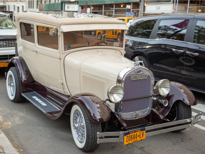 There, four Nowaday cars were parked, including a tan 1928 Ford Model A.