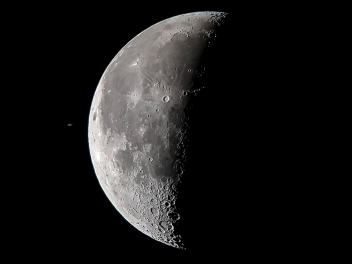 Sometimes, space photography is all about juxtaposition. If you look closely, that tiny dot to the left of the moon in this image is Saturn.