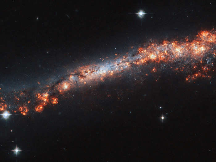 Hubble caught this galaxy in profile, giving astronomers an unprecedented look at its outermost reaches.