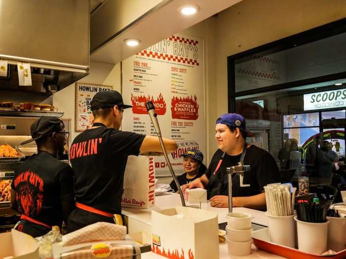 I got a medium spicy chicken sandwich, a side of fries, and lemonade mixed with peach tea. After ordering from the employee at the door, I took a seat at the bar in front of the kitchen.