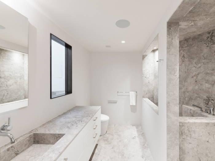 The spa-like master bathroom is outfitted in light gray marble.