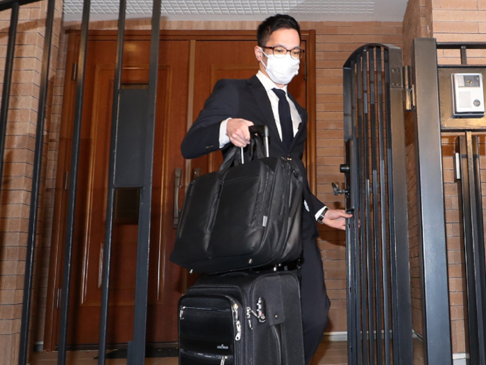 Back in Japan, prosecutors raid his Tokyo home for evidence.