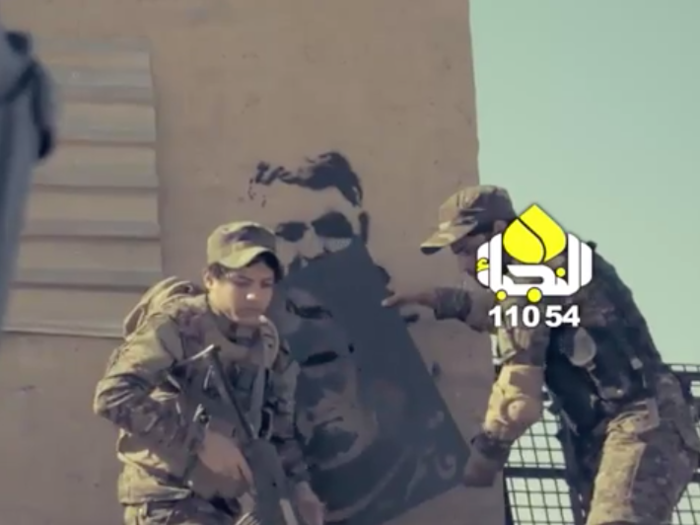 Shia militia fighters also made a music video about him in which soldiers are pictured painting a graffiti portrait of Soleimani