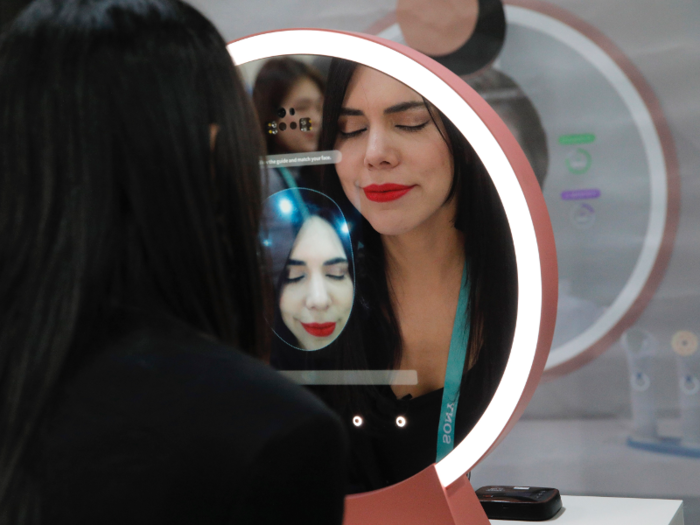 A woman tested out Lumini Home, an AI mirror that provides skincare analysis, which is made by South Korean company Lulu Lab.