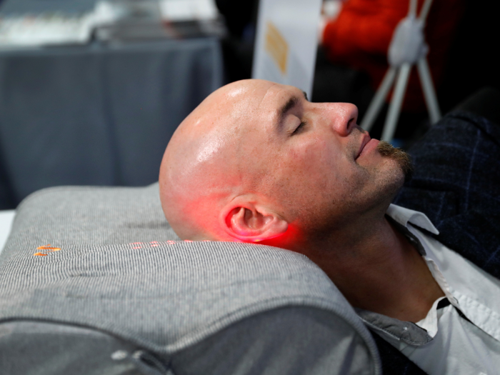 A man demonstrated Motion Pillow, an anti-snore device that detects and analyzes snoring patterns. If it senses that you