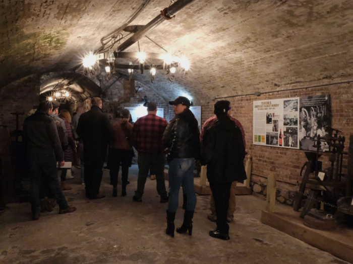 We walked down a few steps into a dimly lit vault filled with original winemaking equipment, including wine presses and corking machines.