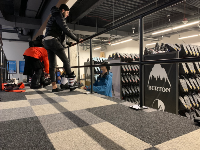 Next, it was time to get boots. Guests climb up onto a platform so that Big Snow employees can easily fit them for boots.