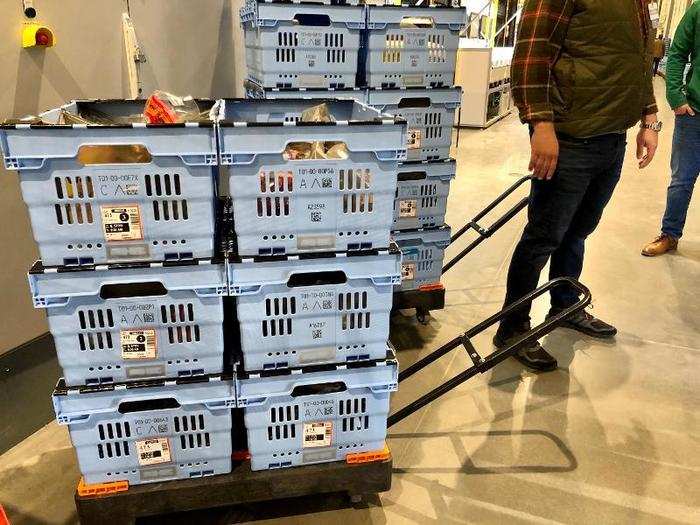 After retrieving an order, employees stack them on these rolling carts for easy transport  to customers