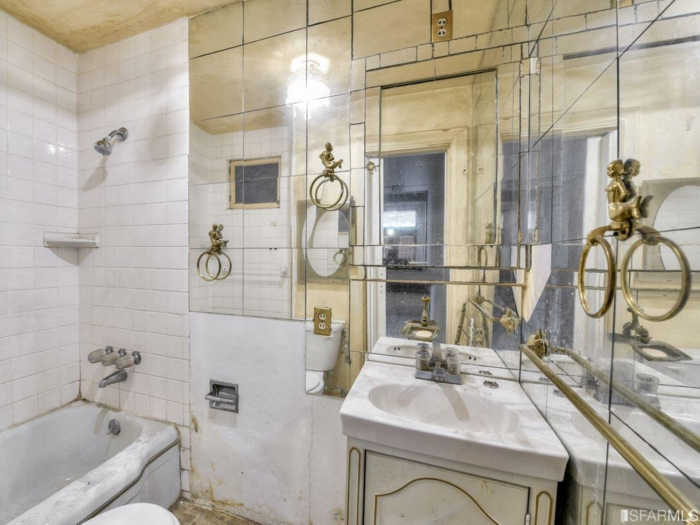 One of the bathrooms is outfitted with panels of mirrors and delicate towel rings bedecked in gold-colored mermaid figurines.