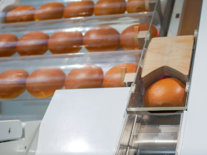 Once a customer orders, a brioche roll from a local bakery is pushed through an air tube into a chute at Creator.