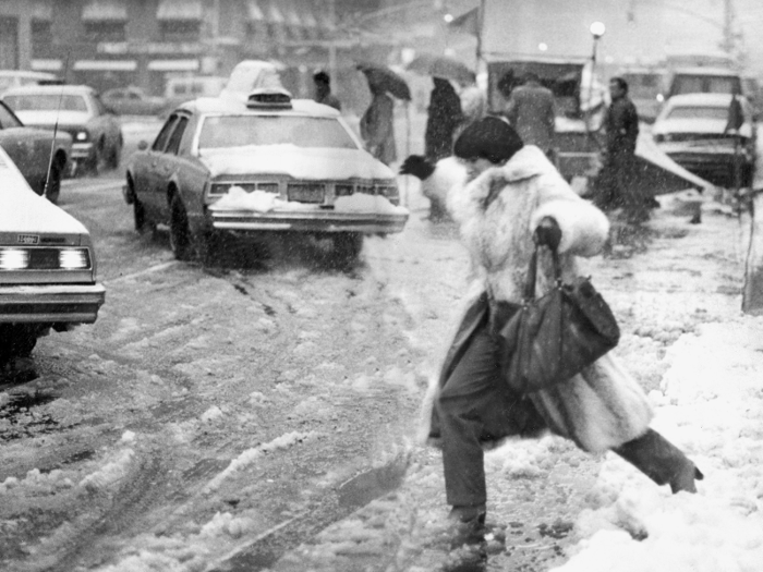 In 1982, a pedestrian balanced precariously on slush as she tried to cross the road during a blizzard.