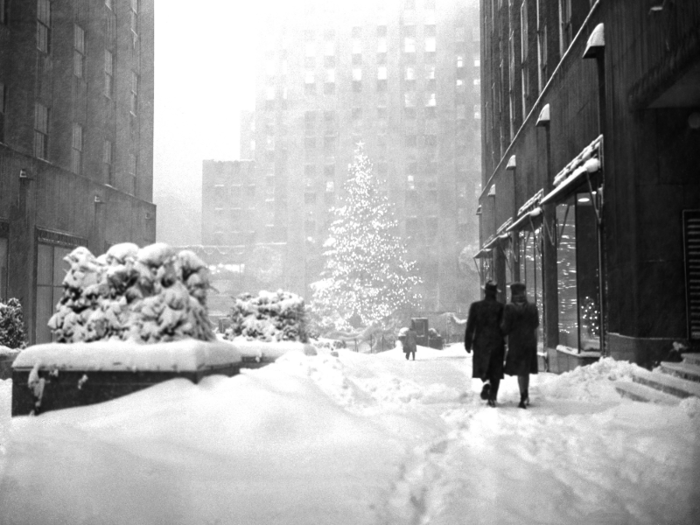 In 1947, a few hardy pedestrians made their way toward the Christmas tree at Rockefeller Plaza in Manhattan.