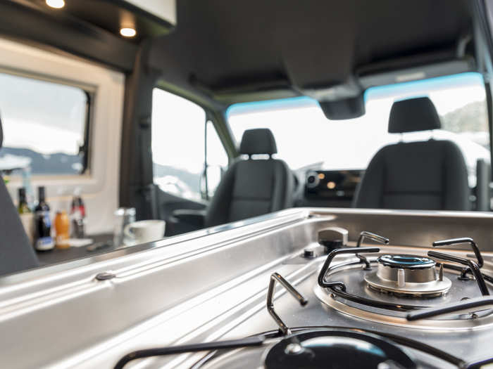 The kitchenette includes a gas burner, refrigerator, and sink.