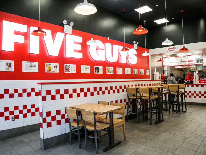 Five Guys uses the exact same color tiling — red and white — as In-N-Out. But somehow its spaces feel more stark and functional.