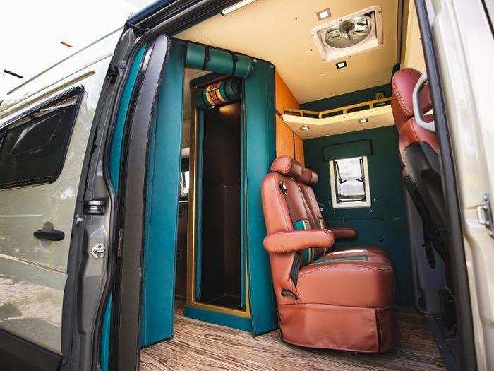 There is an aluminum shower in the middle of the van behind the passenger seats with a custom made shower curtain that can zip to contain water inside the shower space.